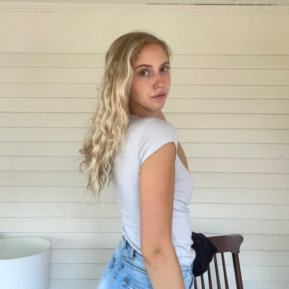 Women’s John Galt baby tee, light blue.